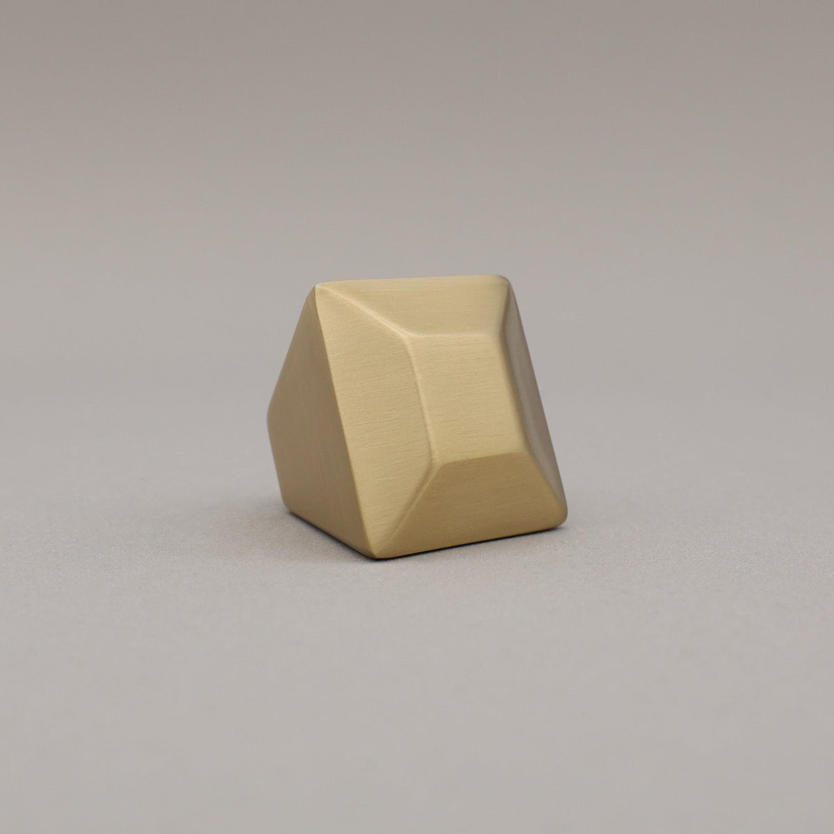 satin brass gold geometric diamond knob on a gray background