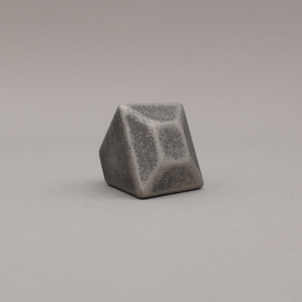 weathered distressed nickel geometric diamond knob on a gray background