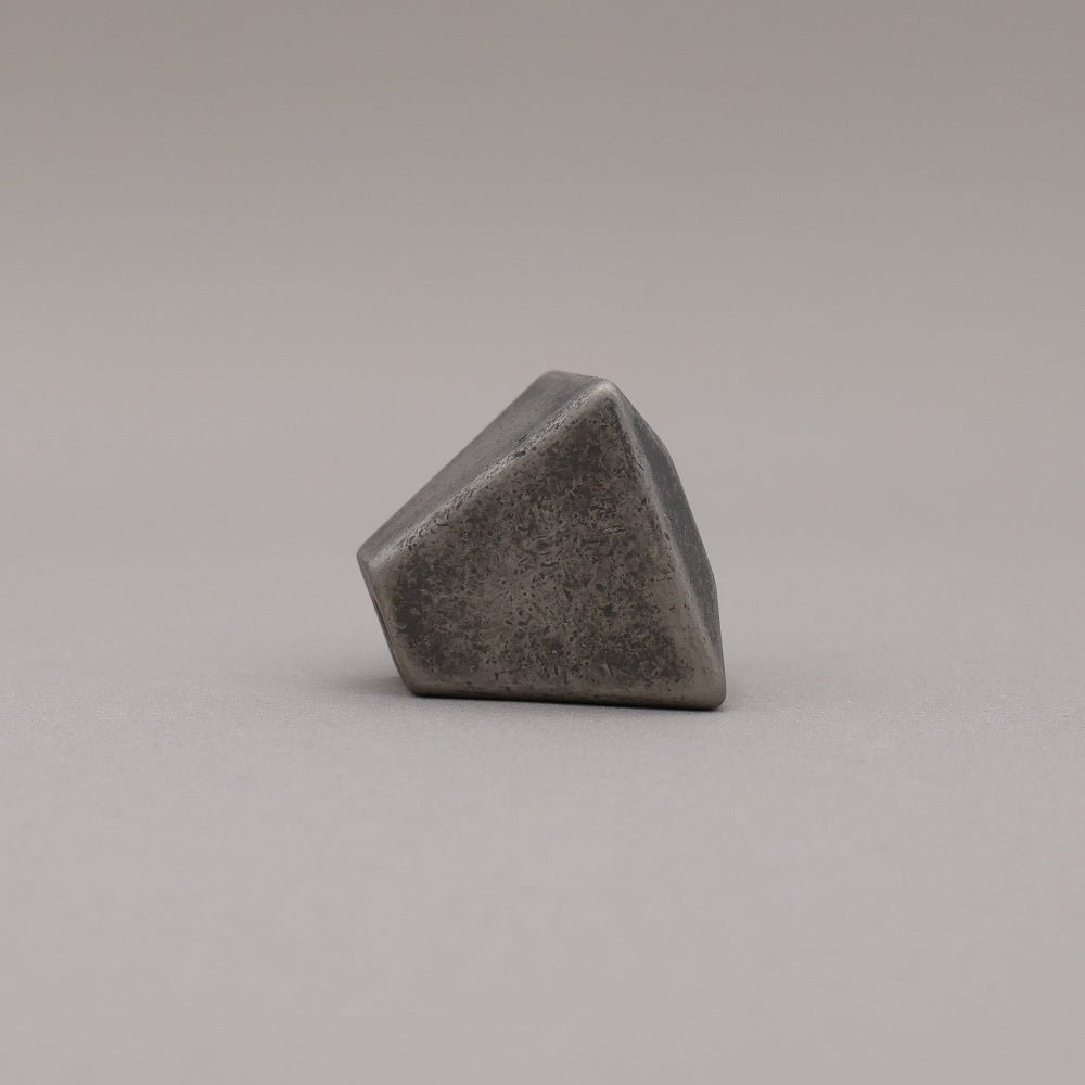 weathered distressed nickel geometric diamond knob on gray background side view