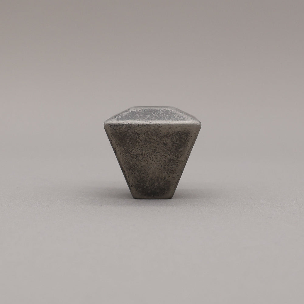 weathered distressed nickel geometric diamond knob on gray background standing
