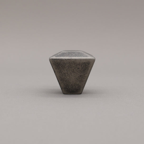 weathered distressed nickel geometric diamond knob on gray background standing