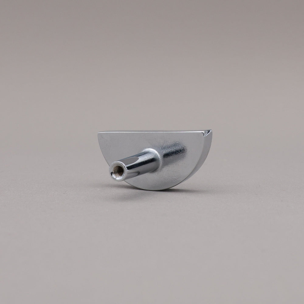 half moon polished chrome knob on gray background rear view