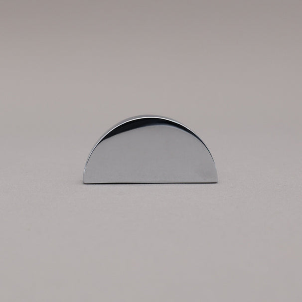 half moon polished chrome knob on gray background