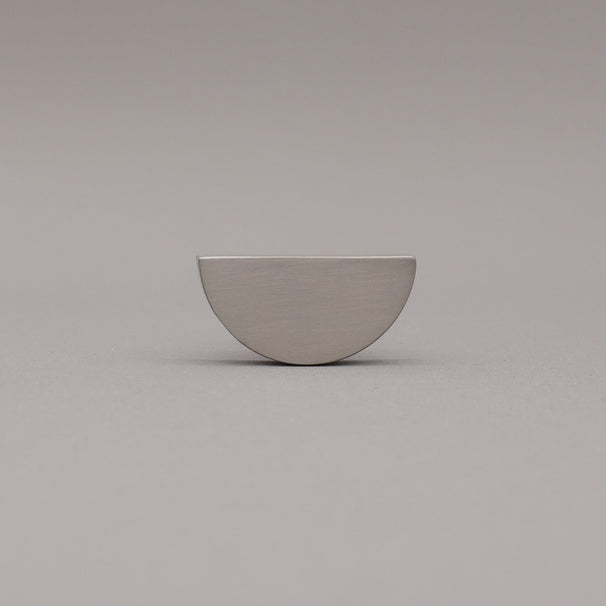 satin nickel silver half-circle half moon cabinet knob on gray background
