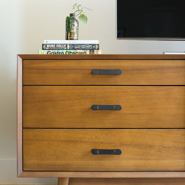 Horizon black cabinet pulls on wood dresser in 5 inch size.