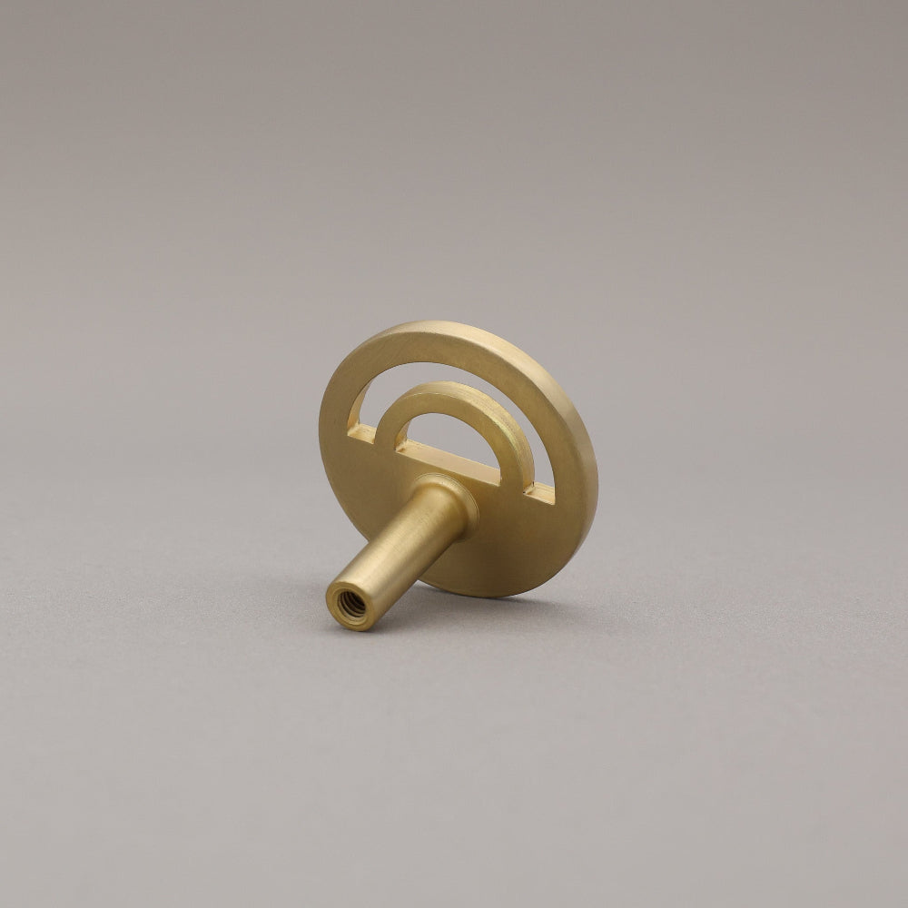 Horizon satin brass knob on gray background
