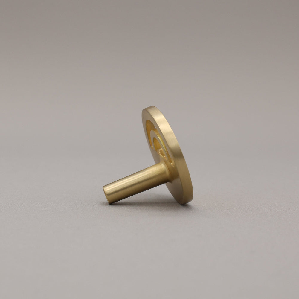 Horizon satin brass knob on gray background