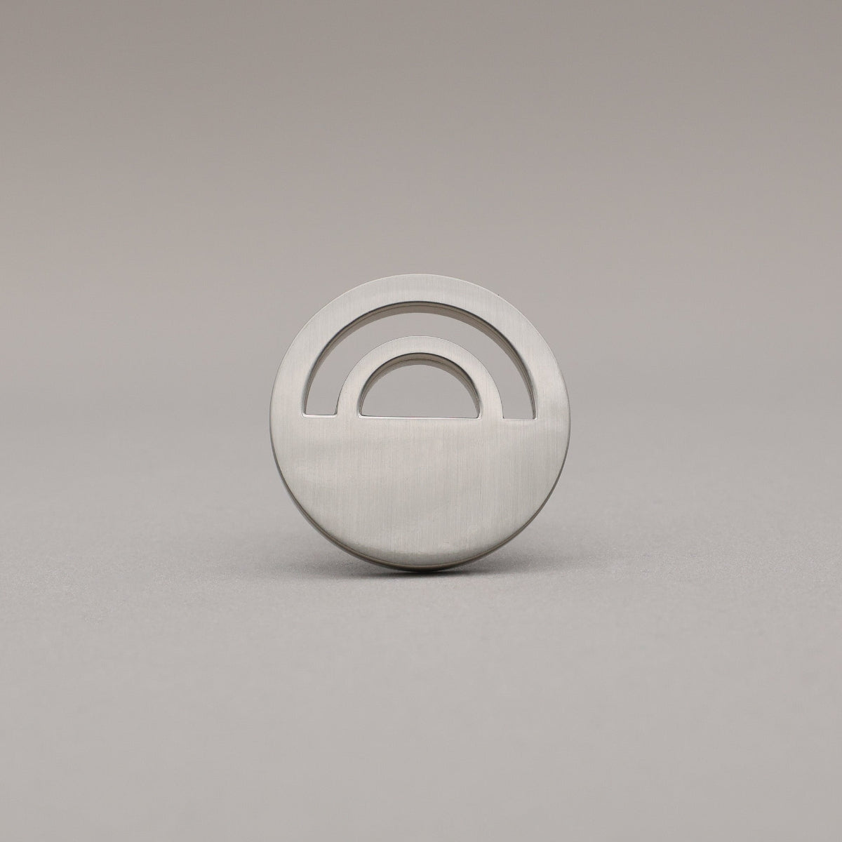 Horizon Satin Nickel Knobs on grey background.