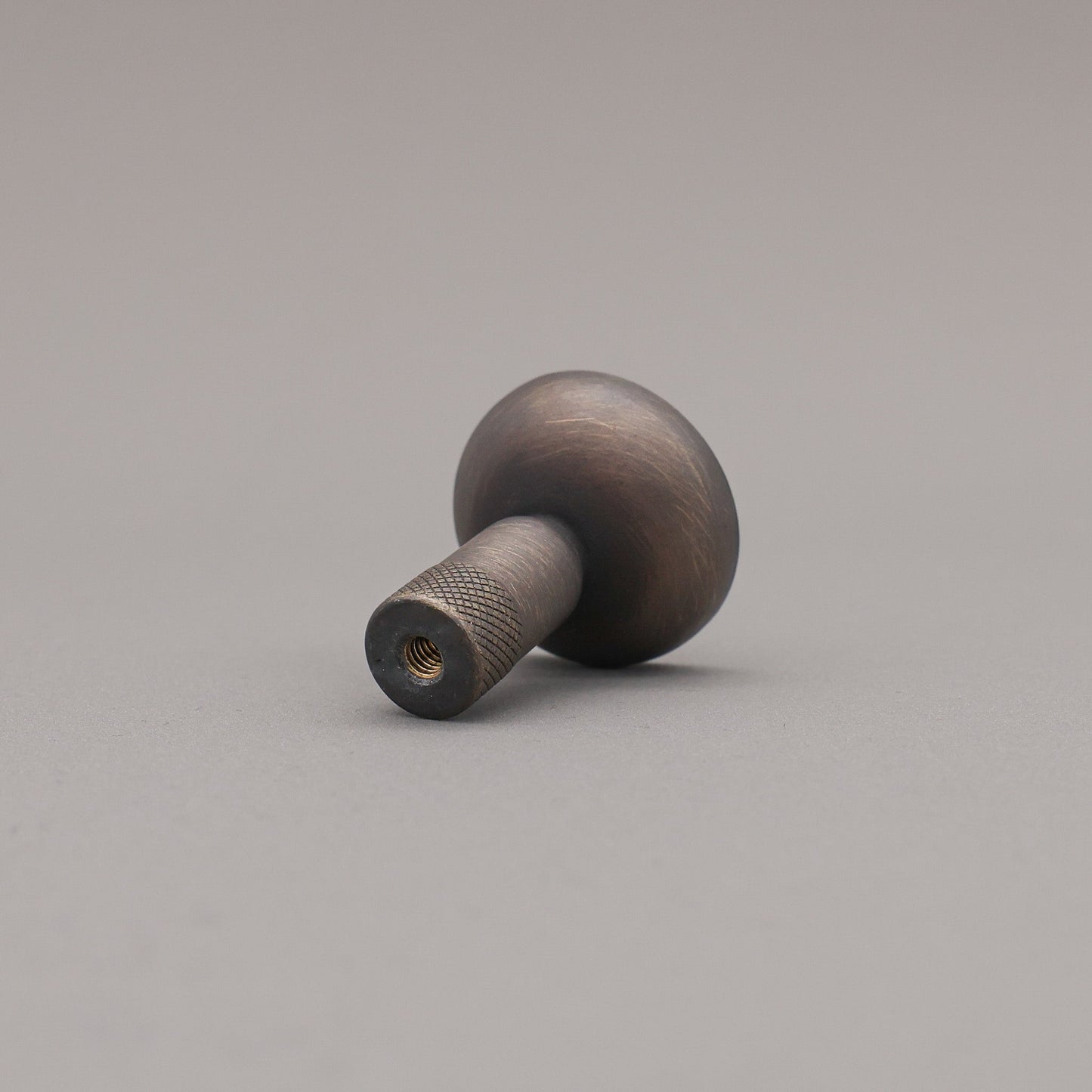 Wooden knob on a gray background