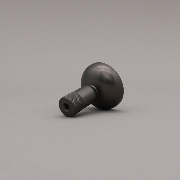Black knob on a gray background