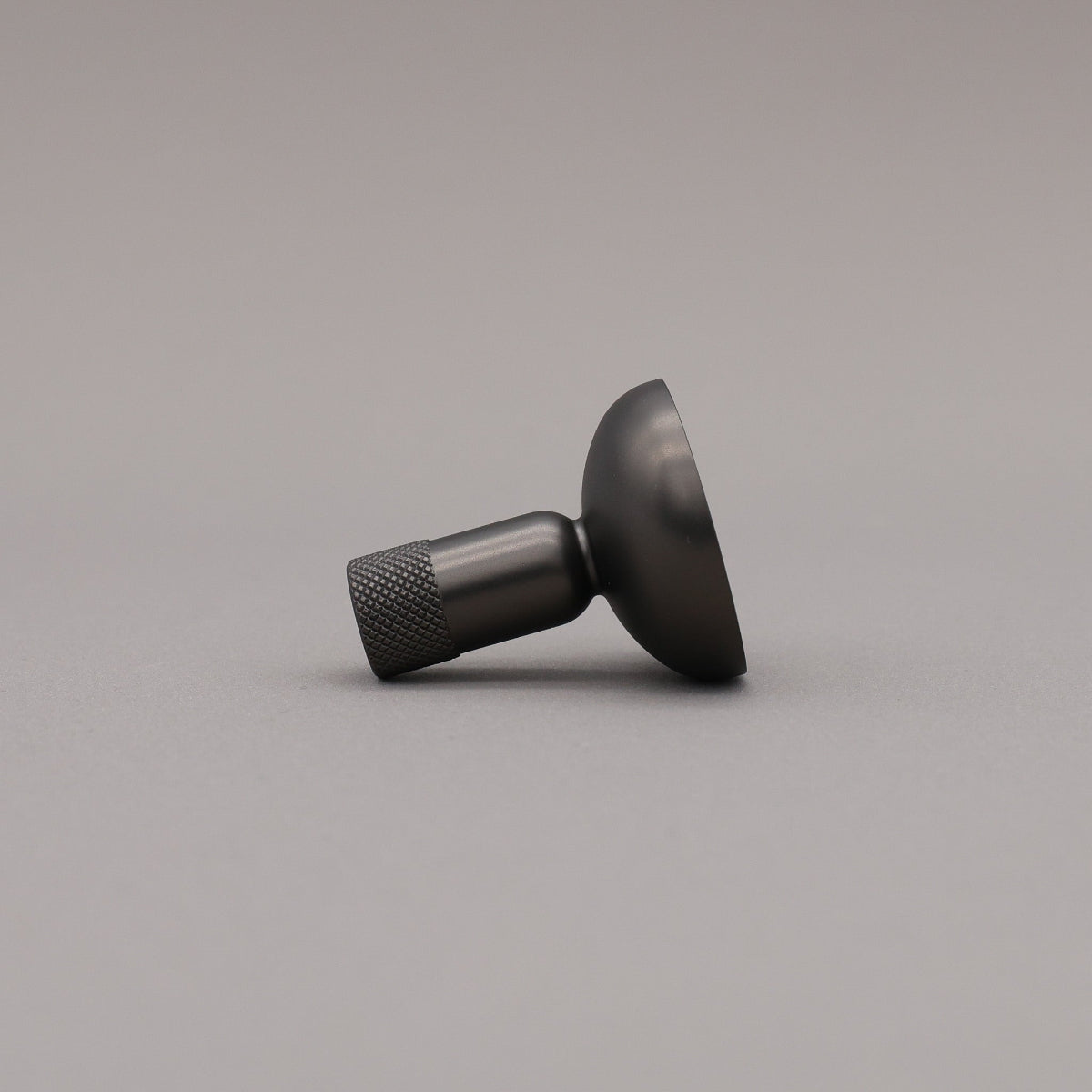 Black metal knob on a gray background