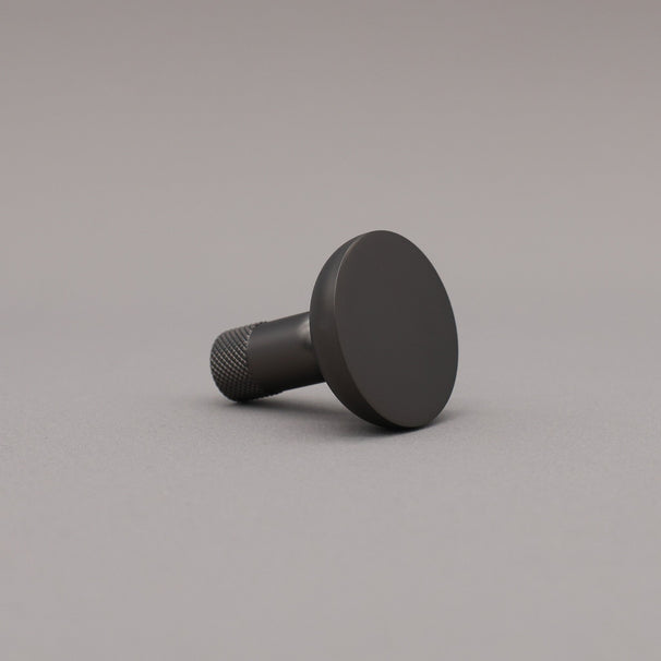 Black knob on a gray background