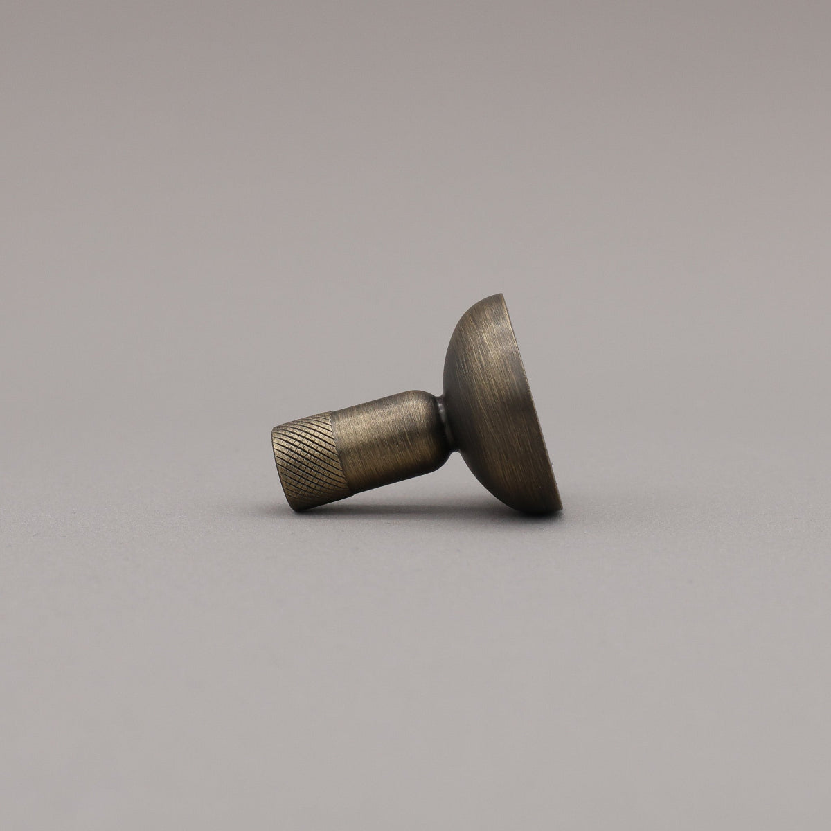 Bronze-colored knob on a gray background