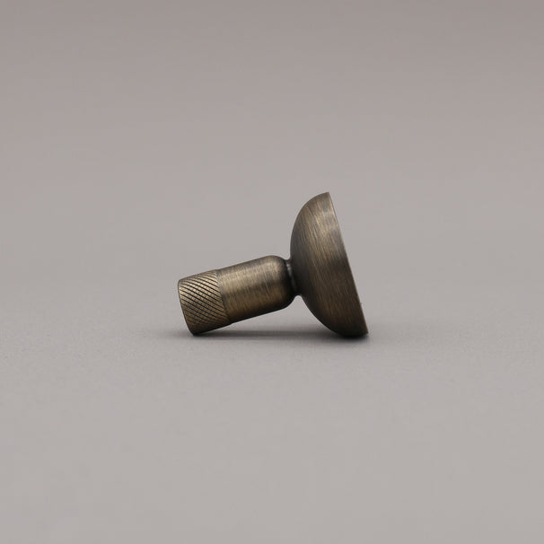 Bronze-colored knob on a gray background