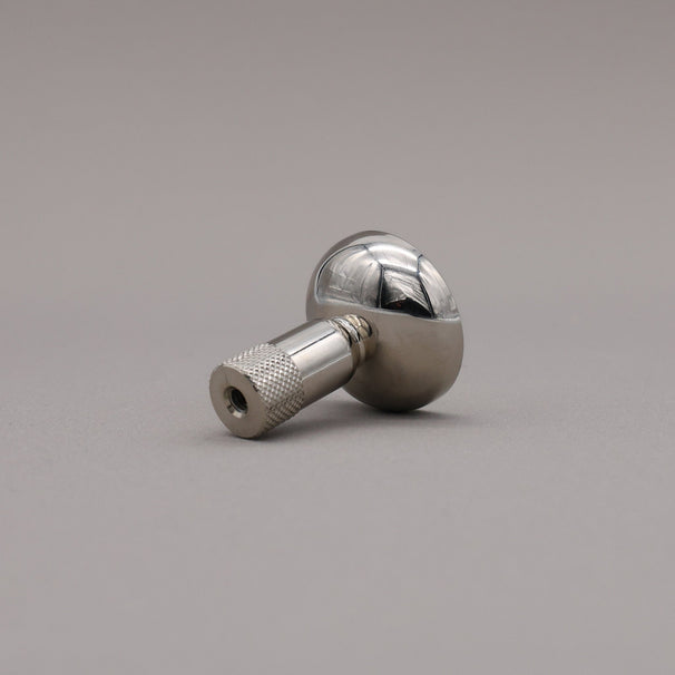 Polished nickel finished knurled cabinet knob on a gray background