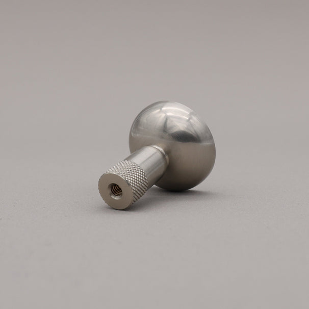 Metal knob on a gray background
