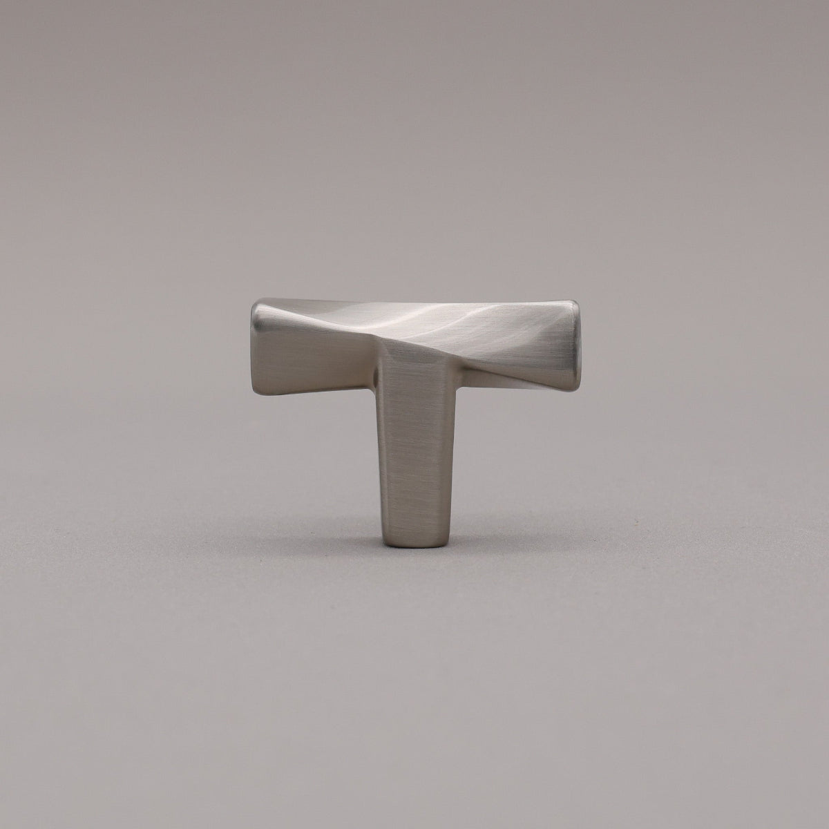 Satin nickel knob on a gray background twist. 