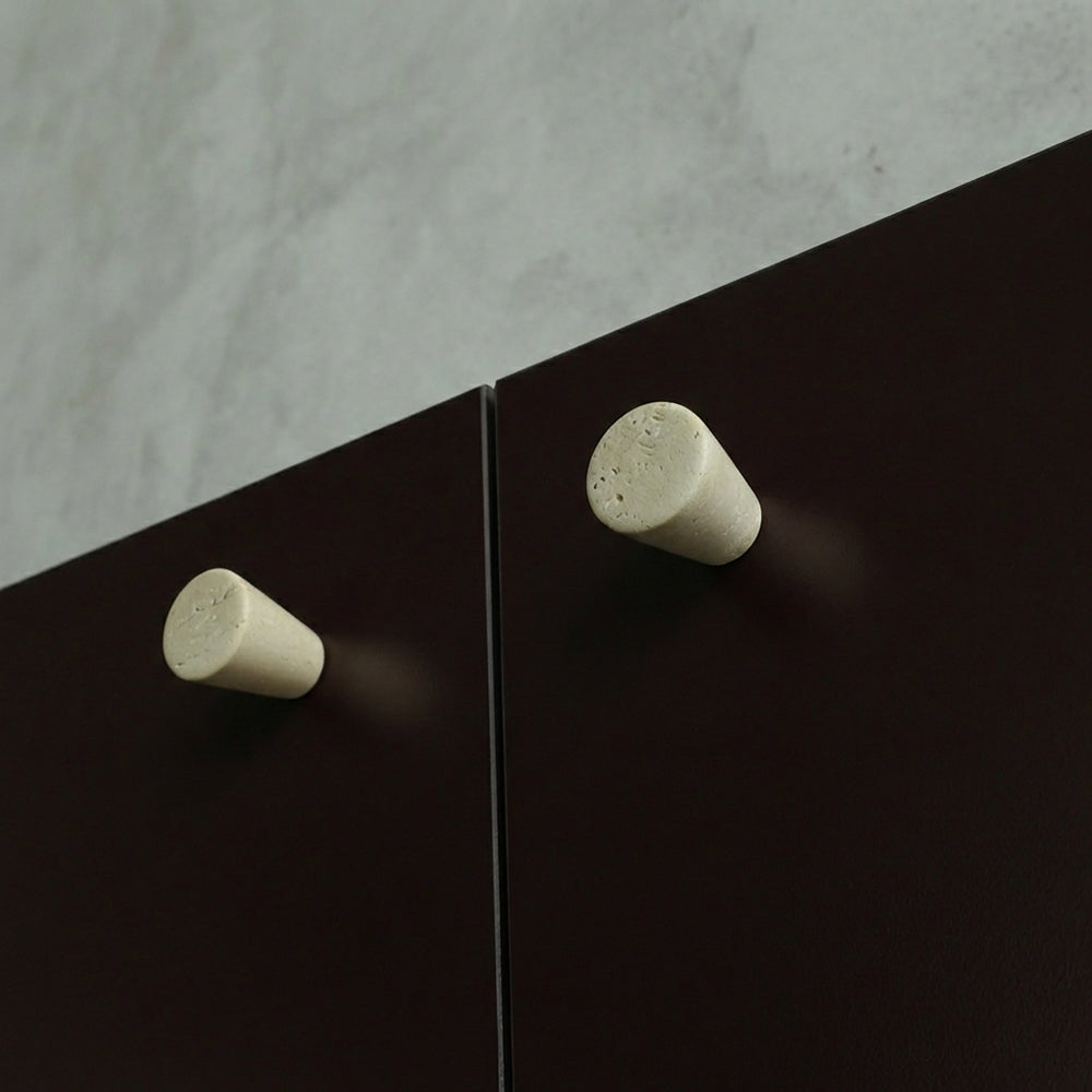 Marble knobs finished in a Travertine on Burgundy cabinets.