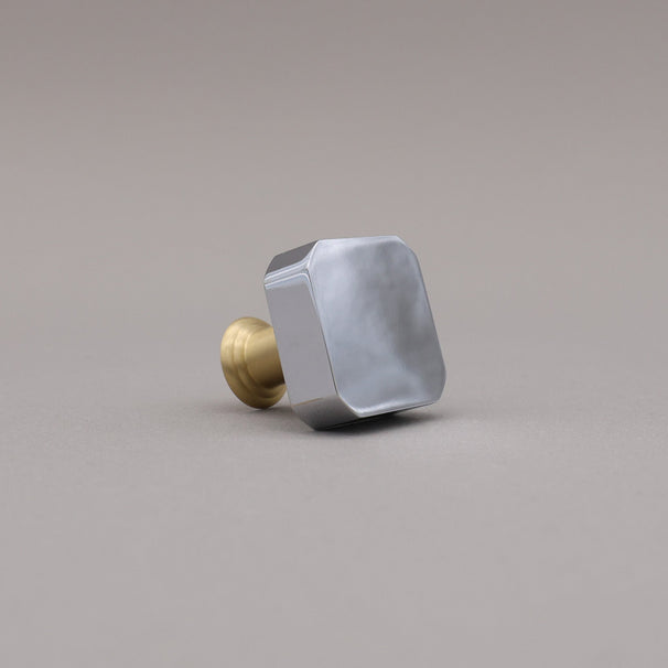 polished chrome and satin brass gold two tone square mod knob on gray background