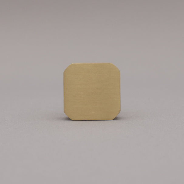 Satin brass gold square knob on gray background