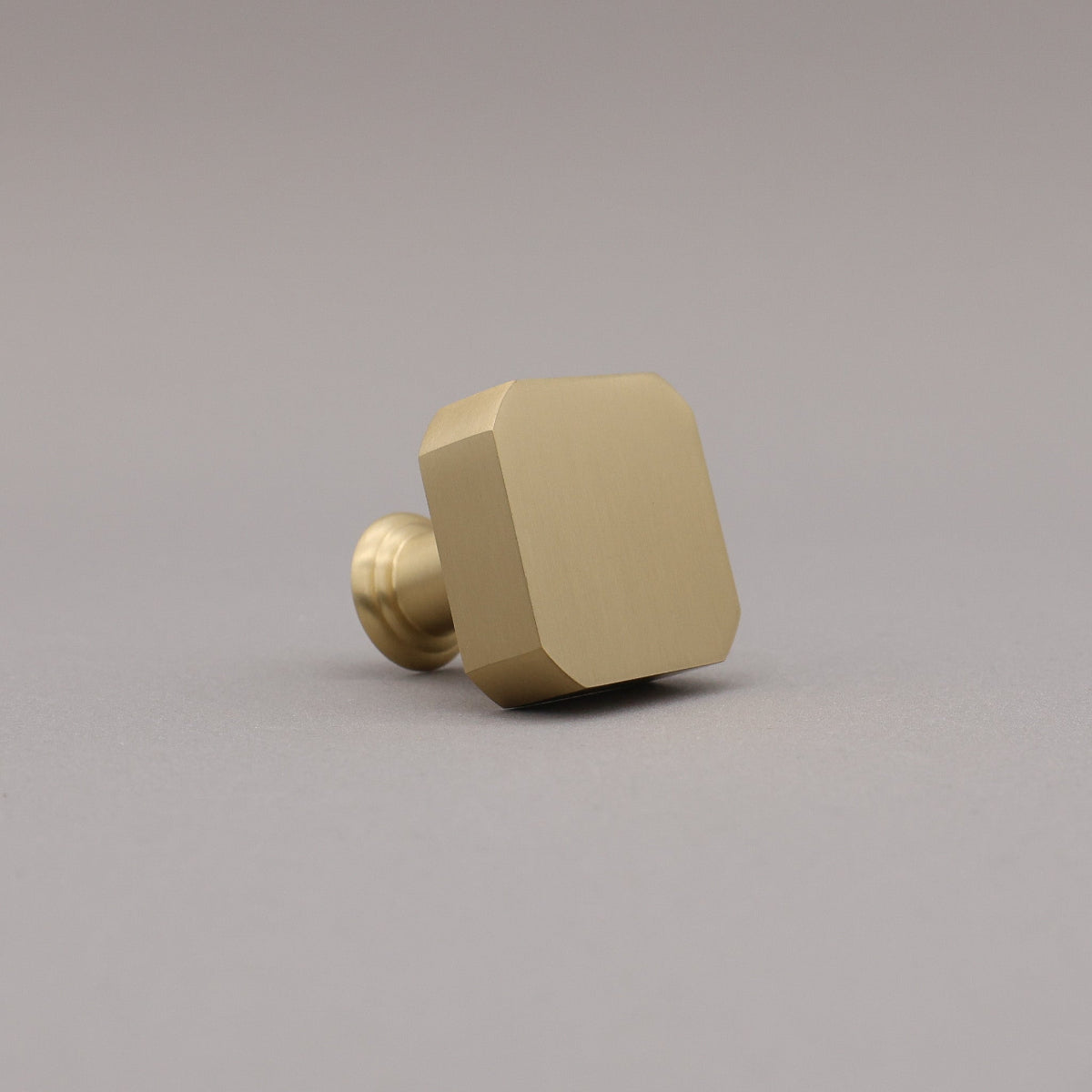 satin brass gold square mod knob on gray background