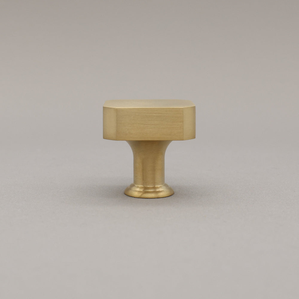 unlacquered satin brass gold square knob on gray background