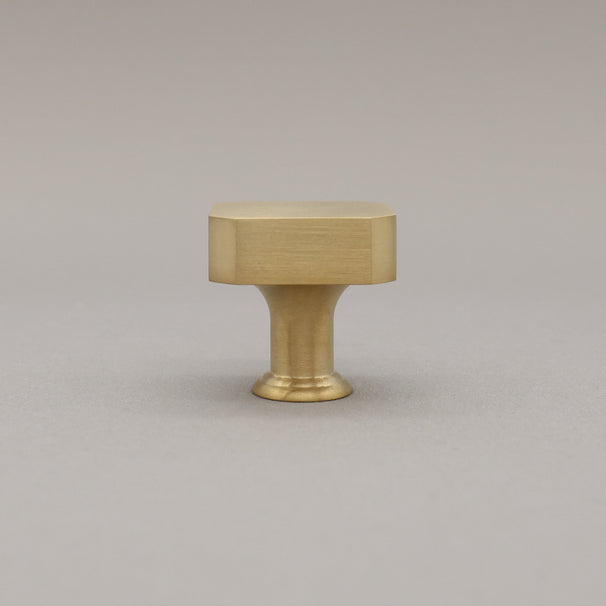 unlacquered satin brass gold square knob on gray background