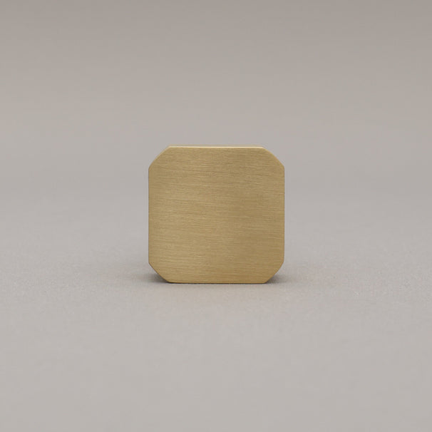 unlacquered satin brass gold square knob on gray background