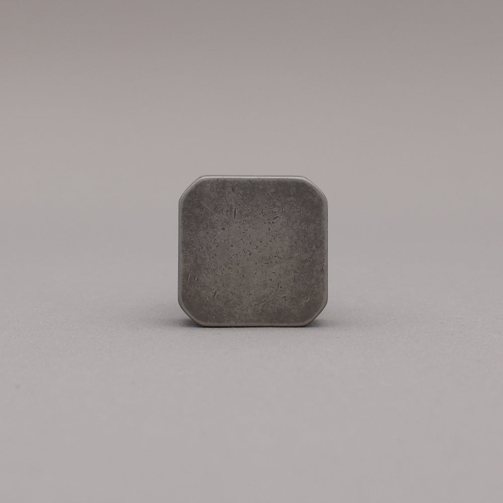 Weathered nickel and matte black two tone square knob on gray background