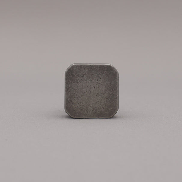 Weathered nickel and matte black two tone square knob on gray background