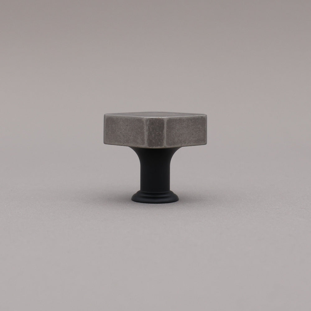 Weathered nickel and matte black two tone square knob on gray background
