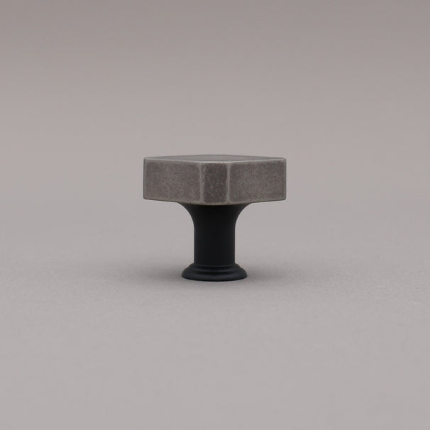 Weathered nickel and matte black two tone square knob on gray background