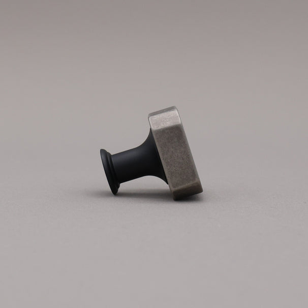 Weathered nickel and matte black two tone square knob on gray background