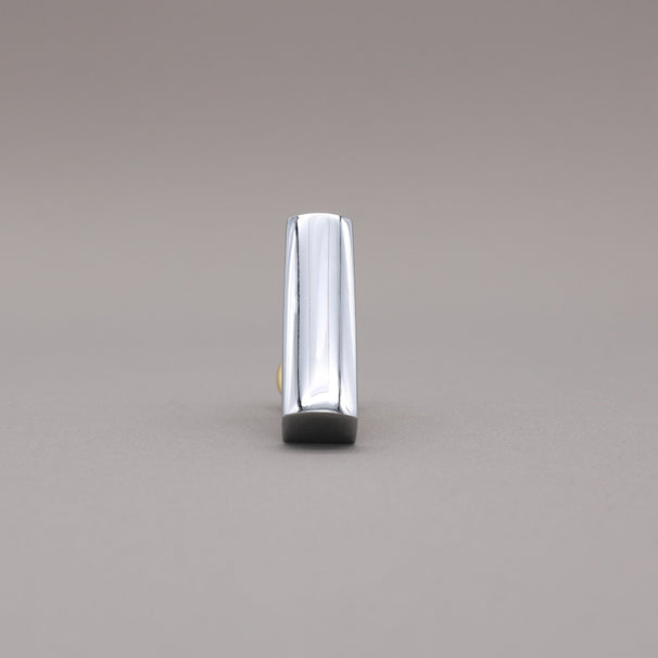 Front facing satin brass and polished chrome t-knob brass cabinet knob on gray background.