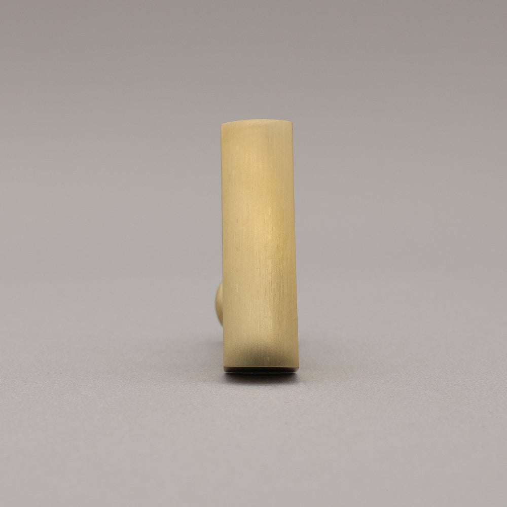Unlacquered satin brass t-knob standing on a gray background front view