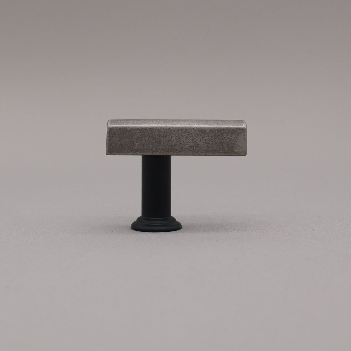 Matte black and weathered nickel two tone t-knob in the mod solid brass collection on a gray background