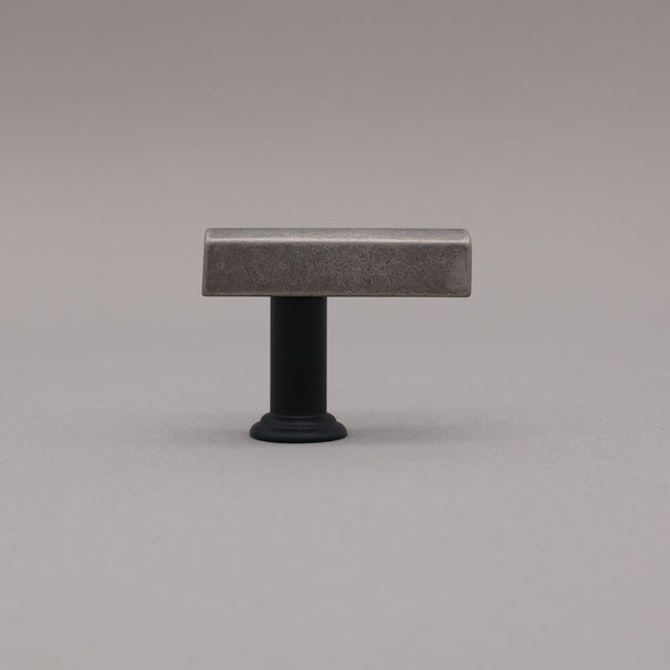 Matte black and weathered nickel two tone t-knob in the mod solid brass collection on a gray background