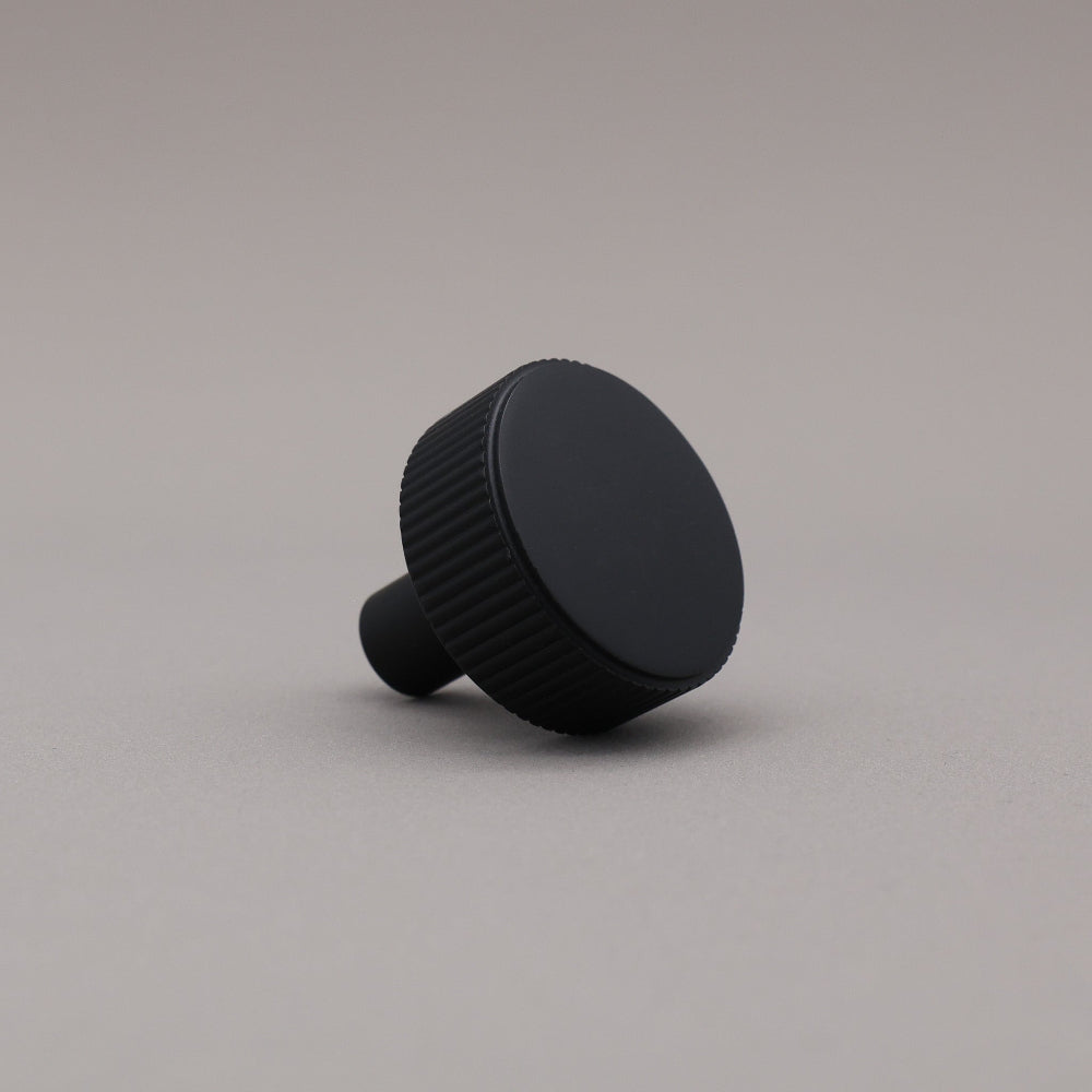 Black knob on a gray background