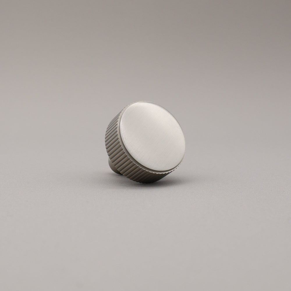 satin nickel silver textured ribbed knob with fluting detail on a gray background
