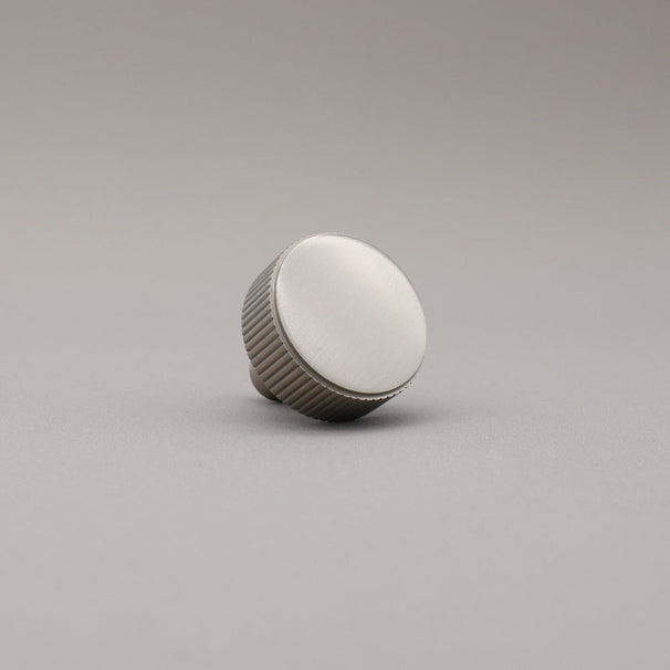 satin nickel silver textured ribbed knob with fluting detail on a gray background