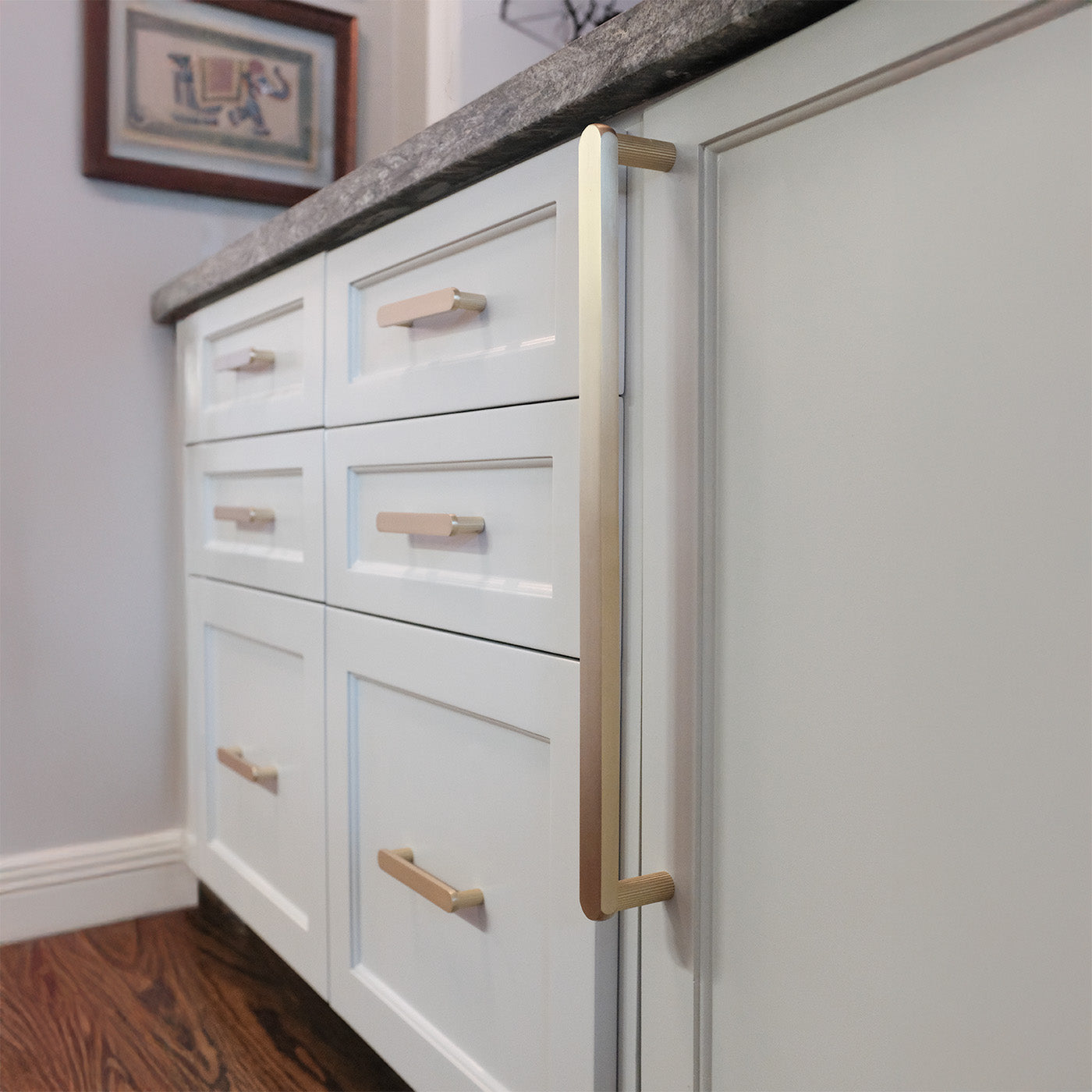 Semi-circle cabinet handles on kitchen drawers.