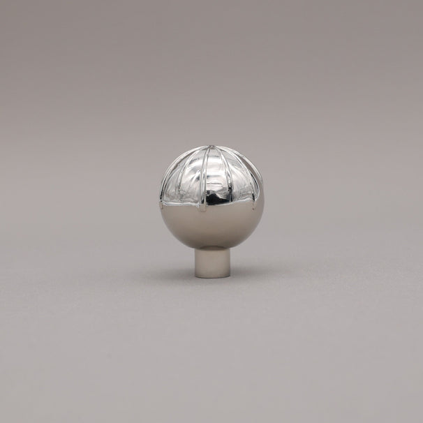 Round sunburst knob polished nickel silver on gray background