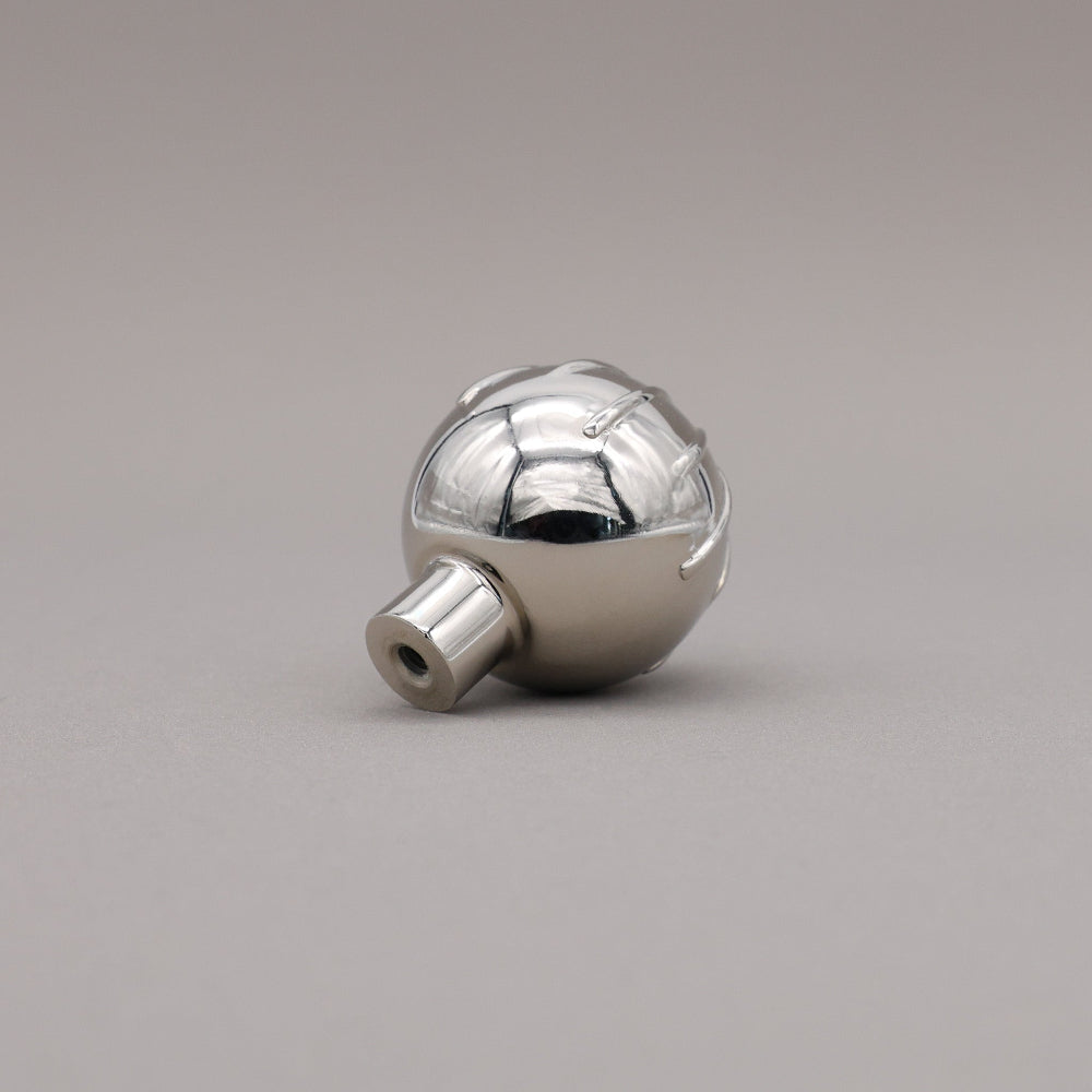 Sunburst round polished nickel knob at angle of back.