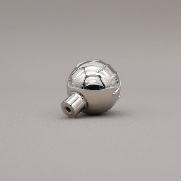 Sunburst round polished nickel knob at angle of back.