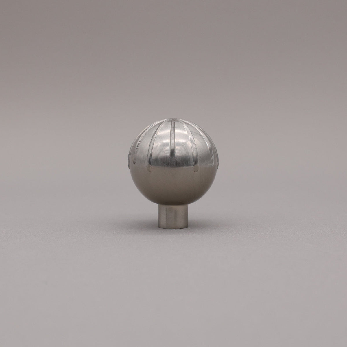 Round sunburst knob silver nickel silver on gray background