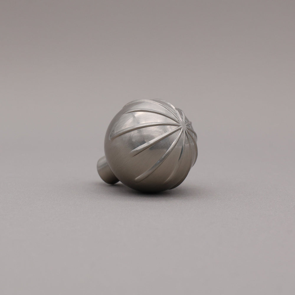 Satin nickel round sunburst knob angled.