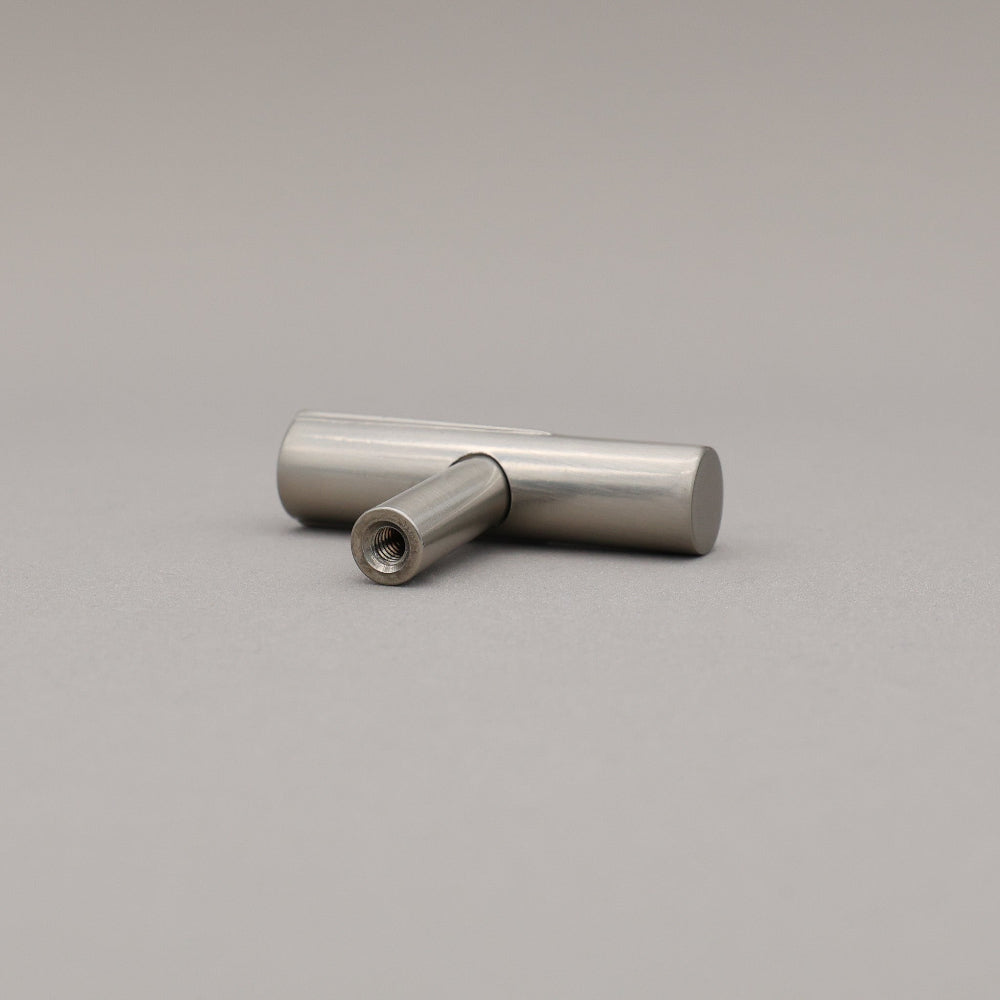 Satin nickel silver t-knob on a gray background