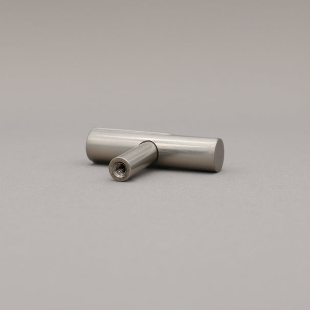 Satin nickel silver t-knob on a gray background