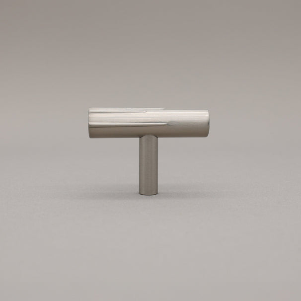 Satin Nickel art deco knob on a gray background.