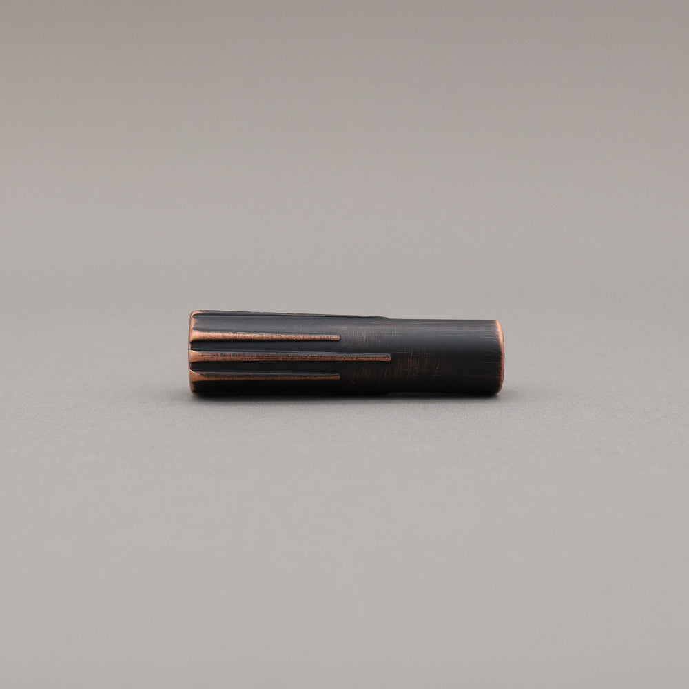 Sunburst venetian bronze t-knob on a gray background